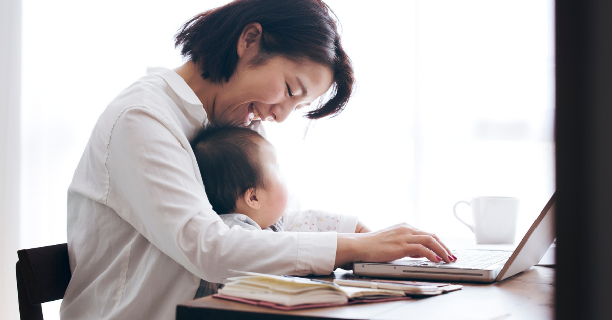 Parent and baby sitting at desk