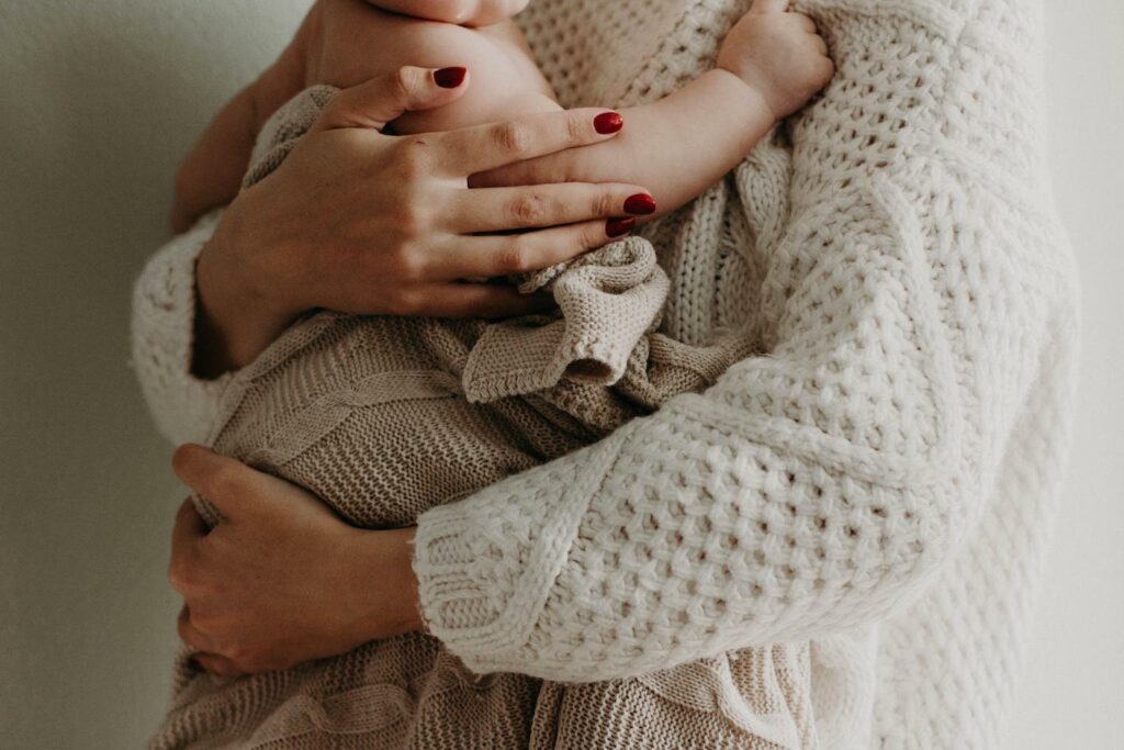 hands holding a baby in a blanket