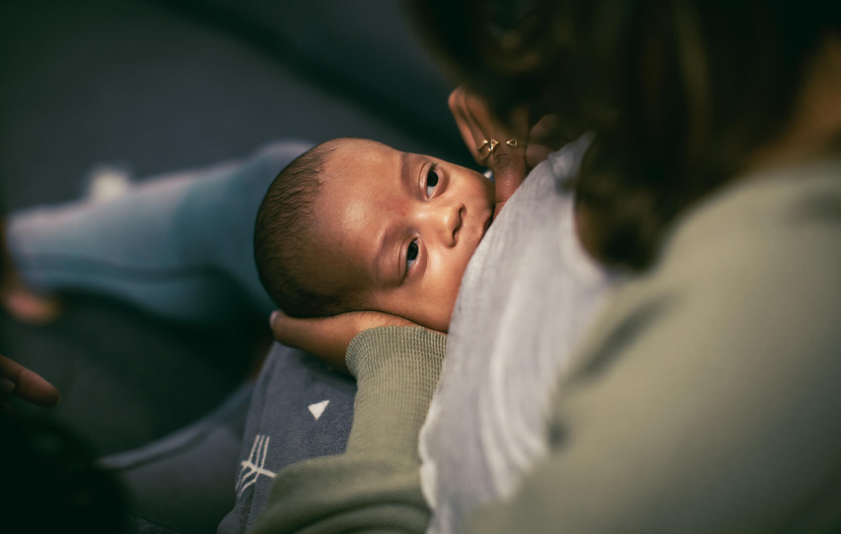 A baby breastfeeding, highlighting the bond between parent and child during feeding.