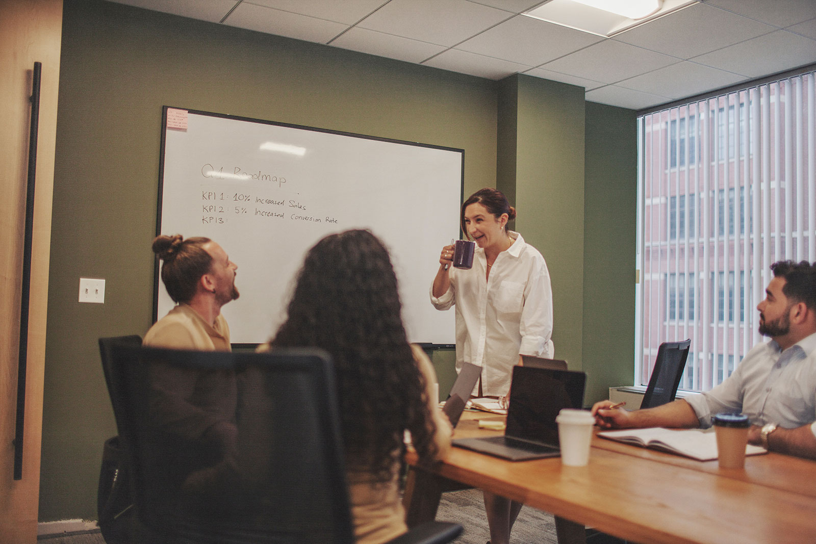 Presentation occurs in boardroom with group of professional people