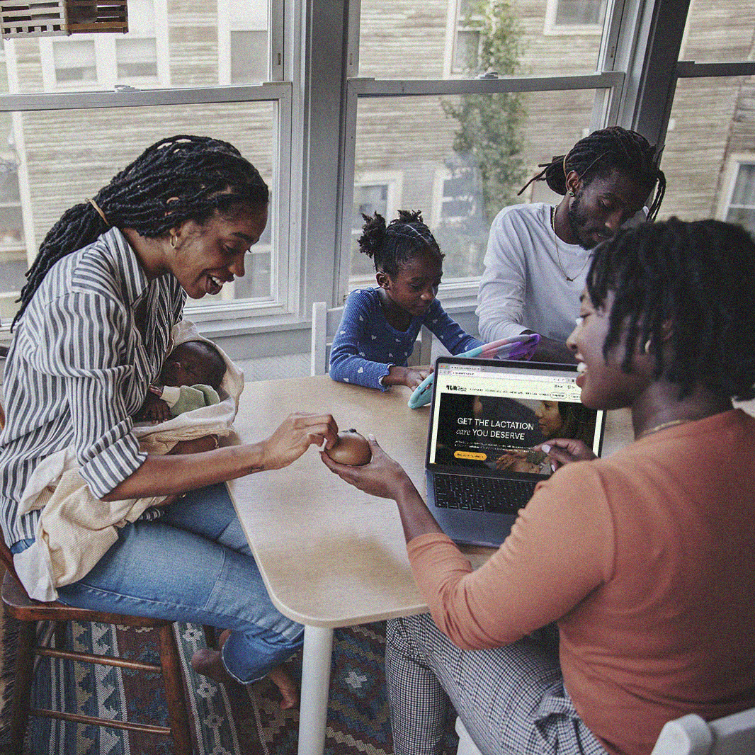 An IBCLC sits with a mom and her family during an at-home consultation.