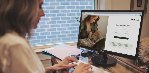 A woman researching The Lactation Network website for breastfeeding support and lactation services.