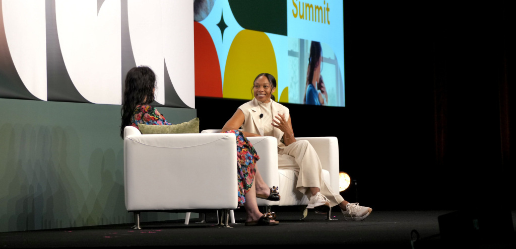 Olympian Allyson Felix smiles while speaking to The Lactation Network CEO, Sarah Kellogg Neff on stage at The Lactation Network 2024 Summit in Chicago, Illinois.