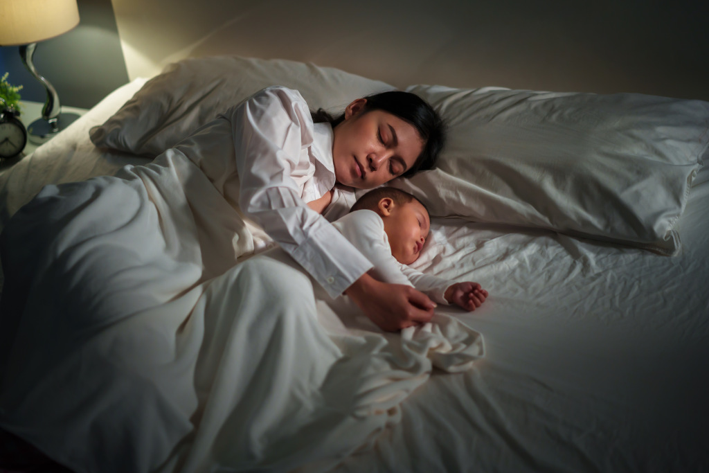 Mother sleeping with baby